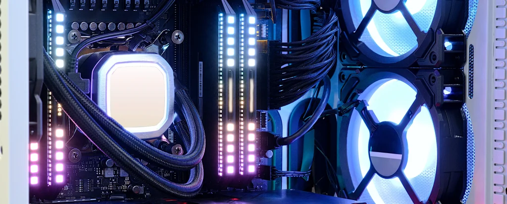 Wnętrze komputera PC z podświetlanym chłodzeniem wodnym CPU, pamięcią RAM RGB i wentylatorami LED, przedstawiające nowoczesny zestaw gamingowy.